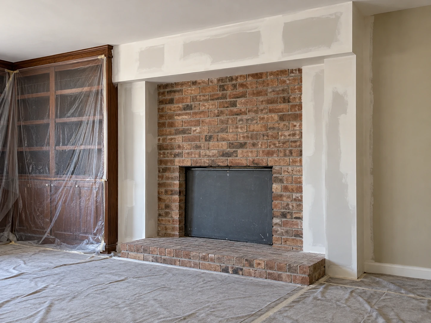 Residential renovation in progress around fireplace