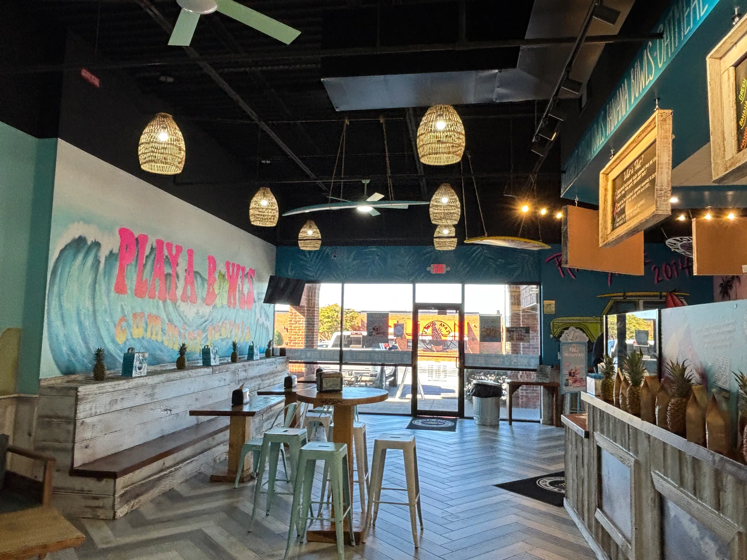 Restaurant dining area with pendant lights, colorful wall finishes, and built-in seating
